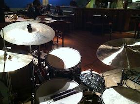 George Brandau's kit at The Menlo Hub. 63 Ludwig Black Diamond finish. I onverted the 16" floor tom into a kick drum. 13" tom, 14" floor tom with fiber skin heads. Hi hats are 14" Dream cymbals. Left cymbal is a 18" K special dry Zylgian Crash. Right is a 20" Dream Ride "Contact" series. 