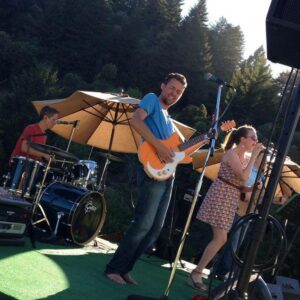 Redwood band performing on outdoor winery stage.