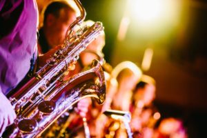 Gold sax player among musicians and friends. Quality relationshiops in action.