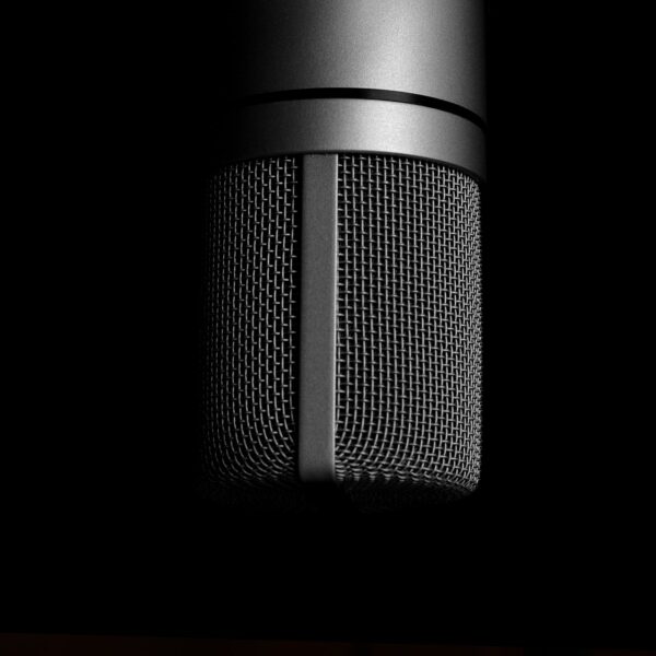 Podcast Startup A course by The Unstarving Musician Microphone on dark background