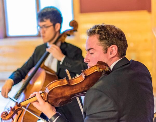 Jared Judge playing violin at a concert