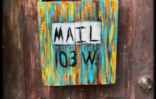 Wooden mailbox multicolor, mounted on door, liner notes newsletter (image by Carlos J. Cuadros @cuadros92 on Pexels.com