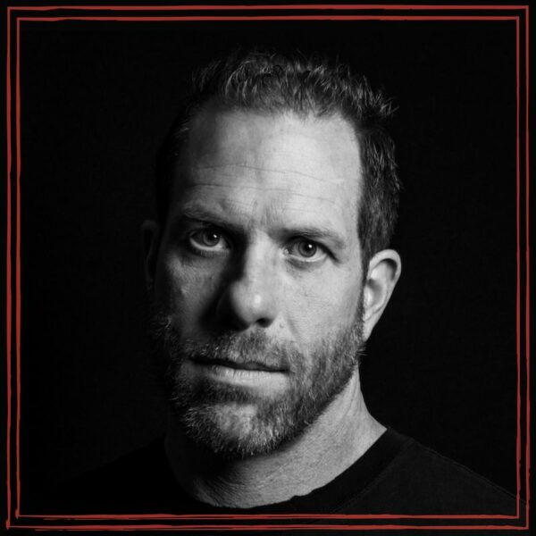 John Templeman, Jib Machine Records, black & white headshot on black background, wearing black crew neck