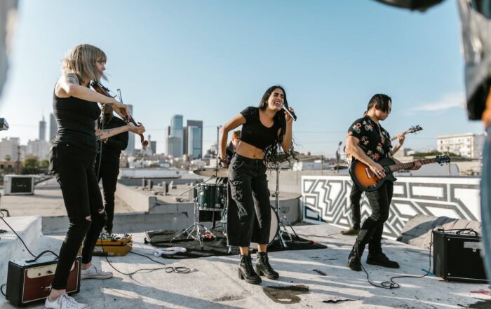 Band performing on outdoor rooftop under blue skys