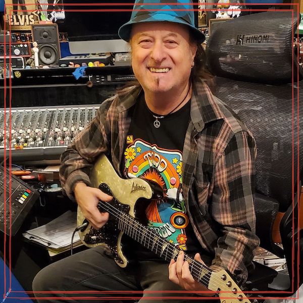 Terry Carleton in Bones & Knives Recording Studio holding electric guitar