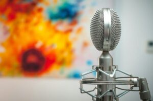silver podcast mic against colorful background