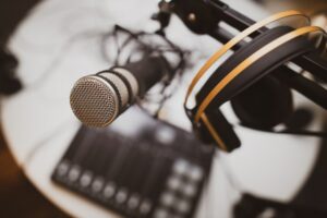 Condenser mic and headphones on boom arm. Image by @farber on Unsplash.com.