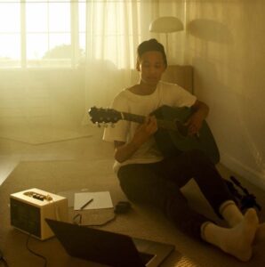Young man sitting on floor playing guitar | Image by @artempodrez on Pexels.com | https://www.pexels.com/photo/a-young-man-sitting-on-the-floor-playing-guitar-4680179/