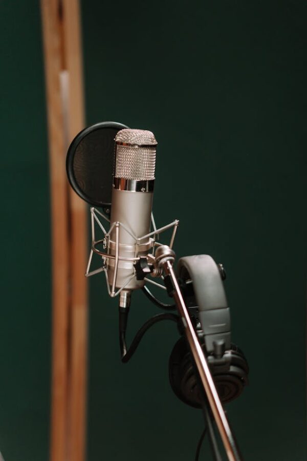 A silver microphone near the black headphones | Image buy cottonbro studio https://www.pexels.com/photo/a-silver-microphone-near-the-black-headphones-7086288/