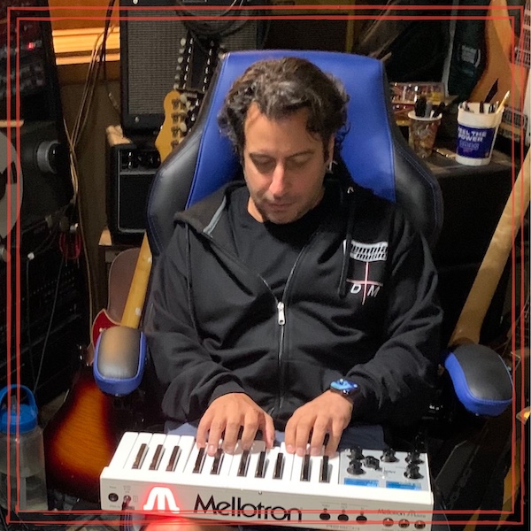 George Ajjan (The ajjancy) playing Mellotron keyboard in studio surrounded by music gear | Creating legal mashups