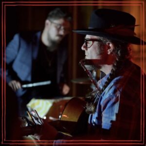 Episode artwork featuring Ezra Vancil playing acoustic guitar on stage