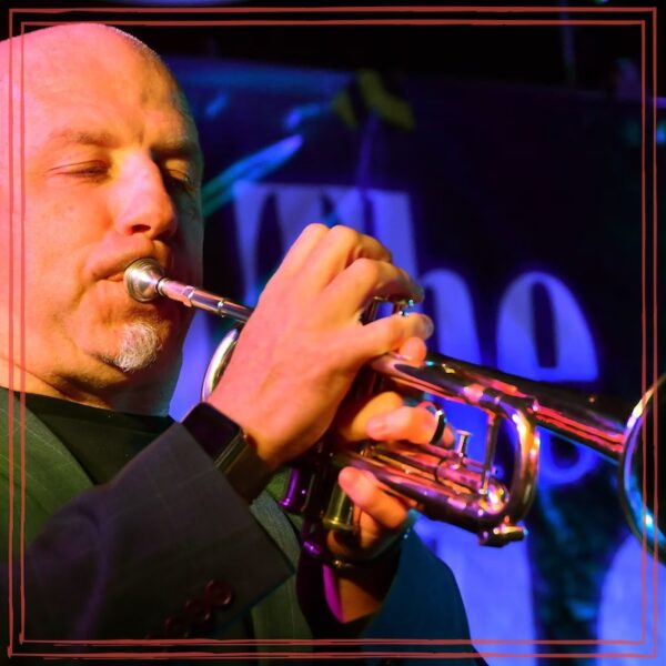 Johnny Thirkell playing trumpet on stage | Unstarving Musician episode artwork Johnny Thirkell playing trumpet on stage | Unstarving Musician episode artwork