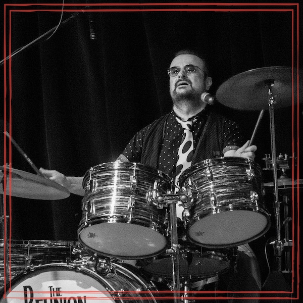 Terry Carleton playing drums at a show for The Reunion, Beatles tribute band.